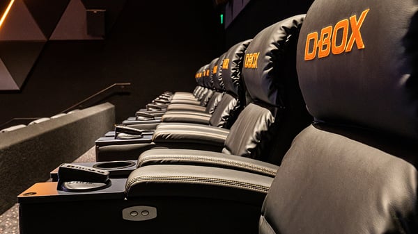 A row of D-BOX cinema seats in an auditorium