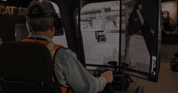 A man driving a construction simulator