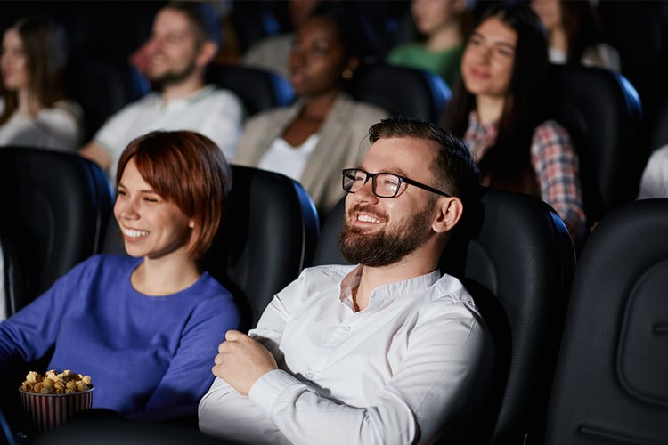 Couple enjoying a movie in a theater