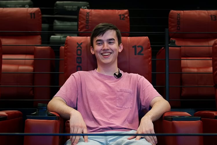 Happy movie enthusiast in a D-BOX seat