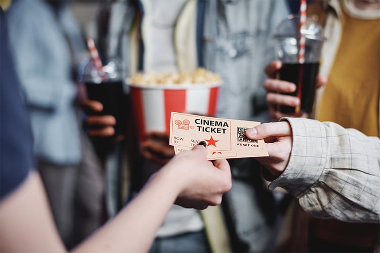 Person handling a movie tickets